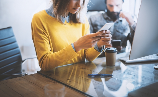 Working,Process,In,Modern,Office.woman,Looking,To,Her,Mobile,Phone holding security of your computer in your hand
